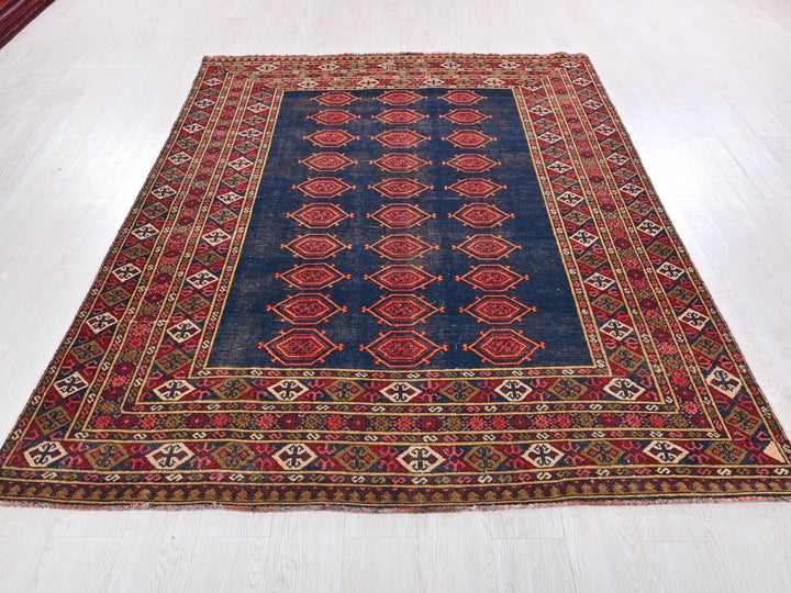 a blue and red rug on a white floor