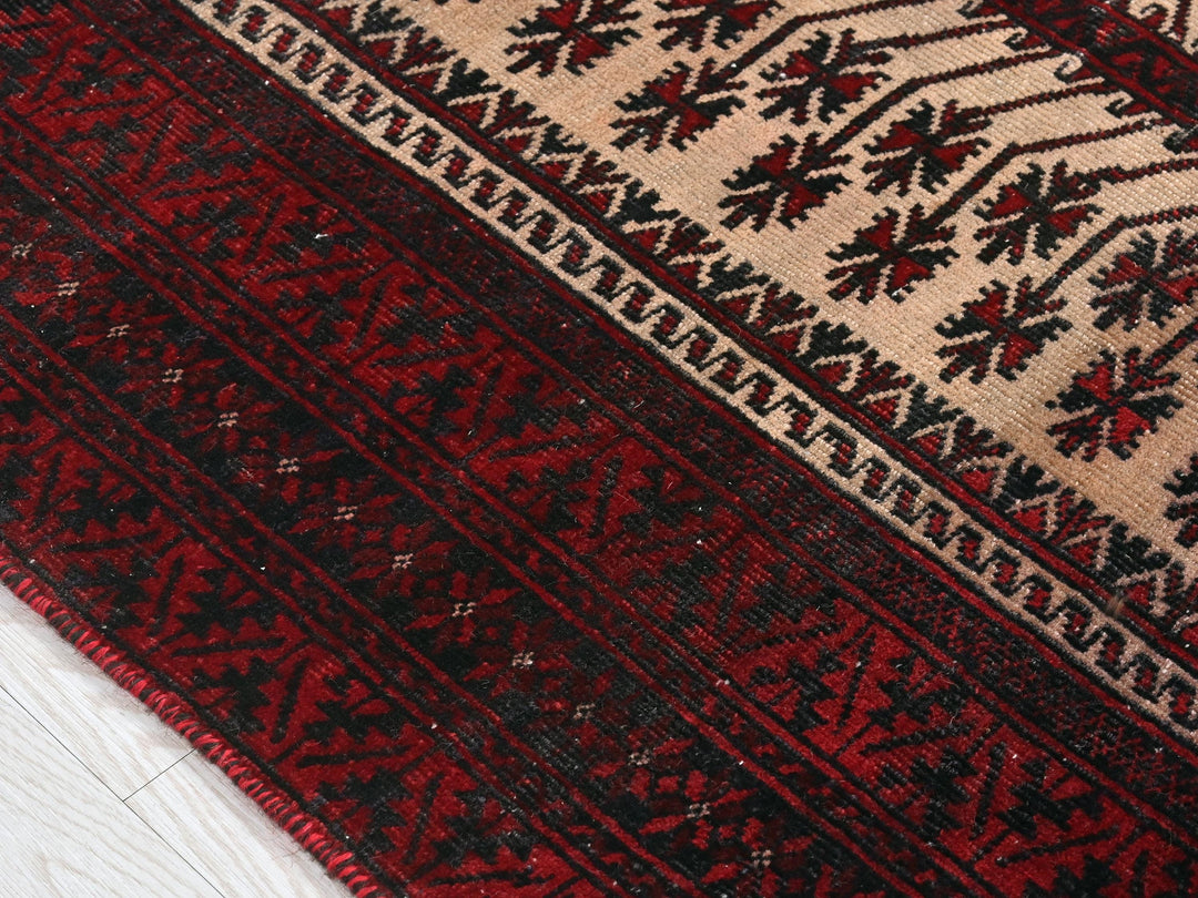 a close up of a red rug on a white floor