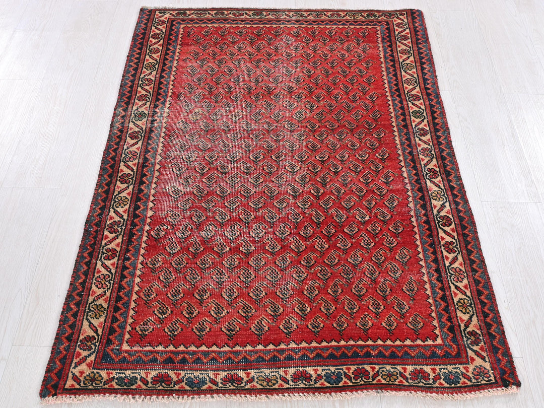 a red rug on a white floor in a room