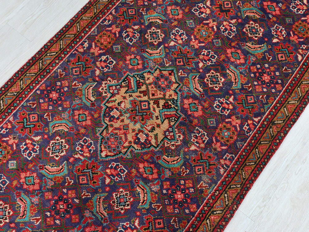 a colorful oriental rug on a white wooden floor