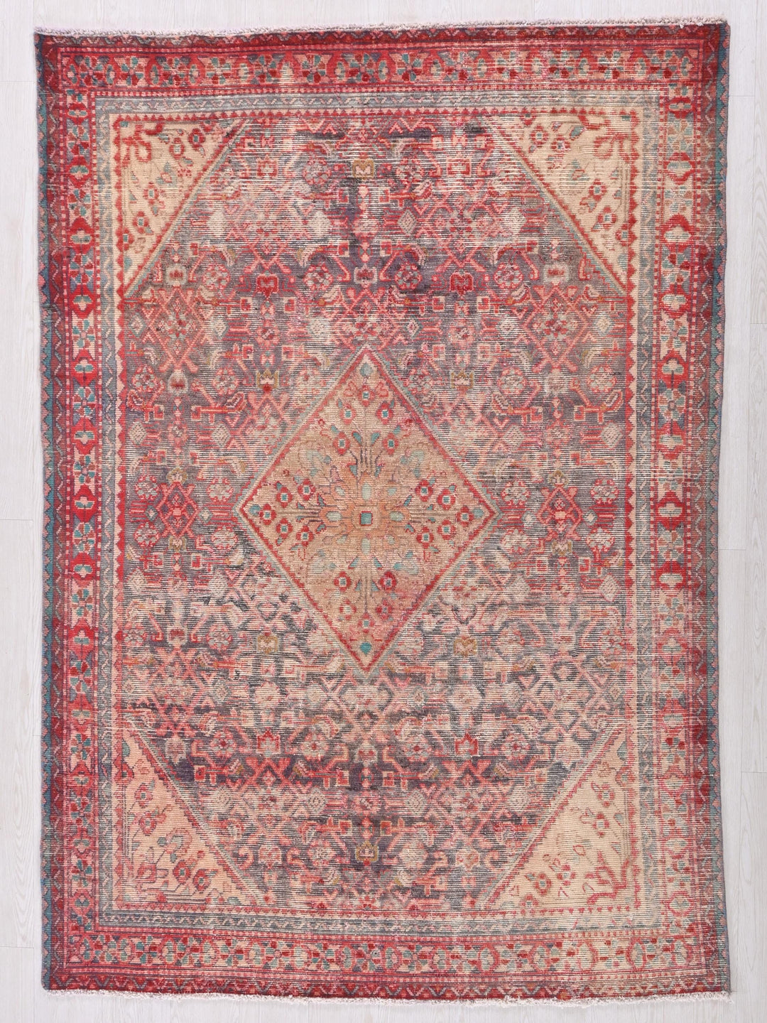 a red and blue rug with a diamond pattern