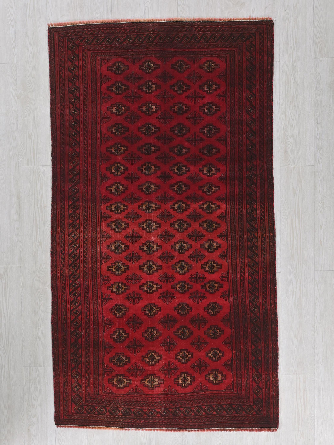 a red rug is on a white floor