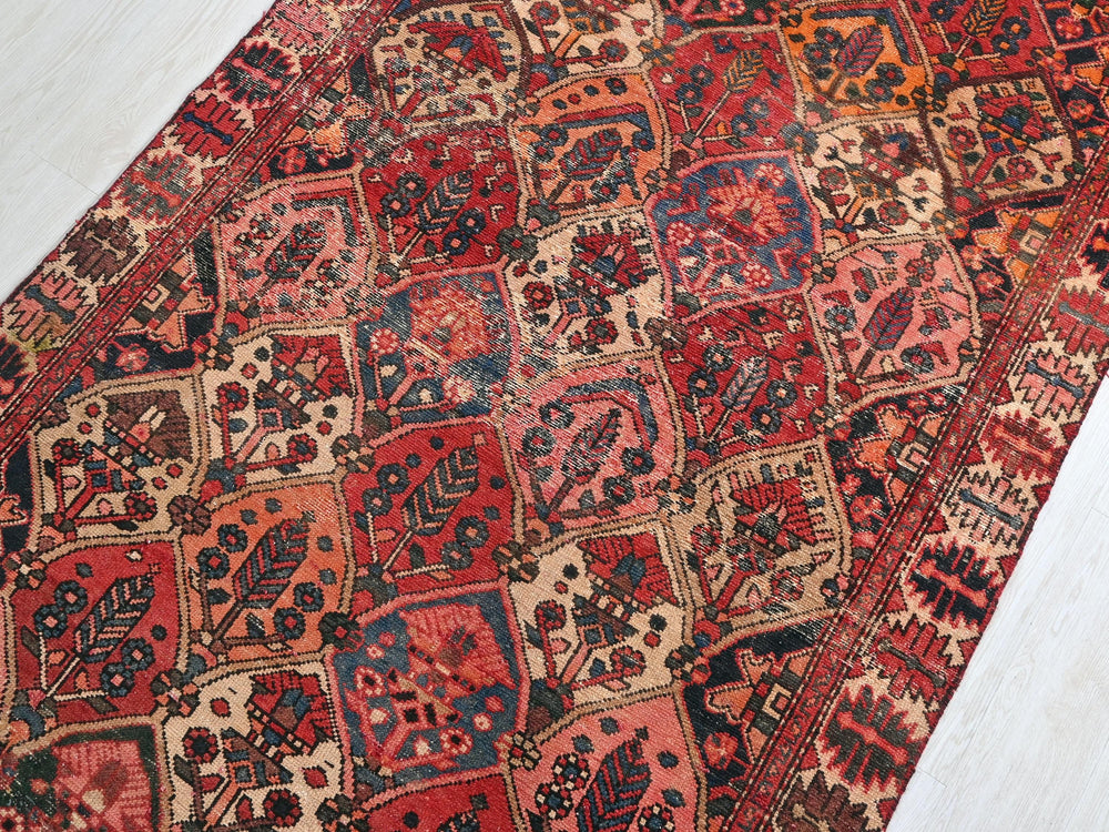 a red and blue rug on a white floor