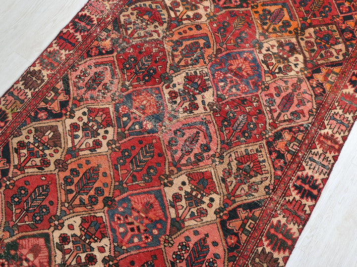 a red and blue rug on a white floor