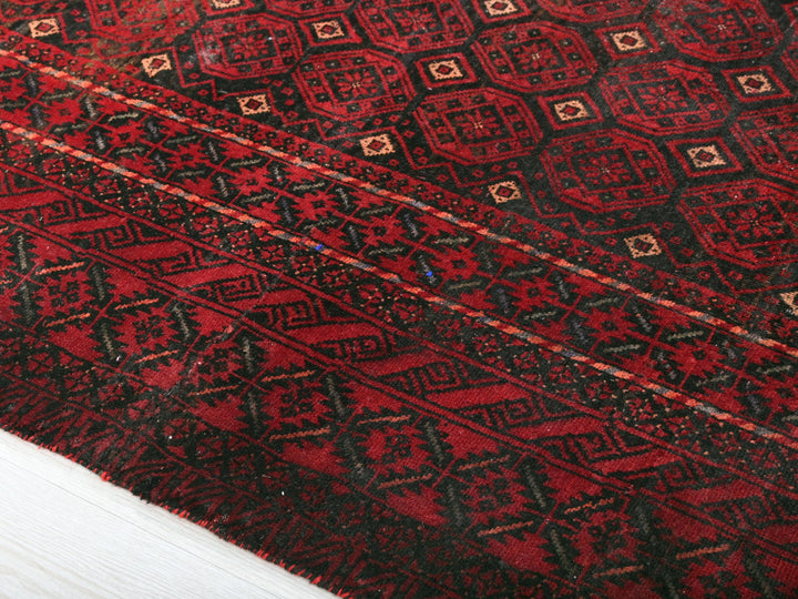 a close up of a red and black oriental rug