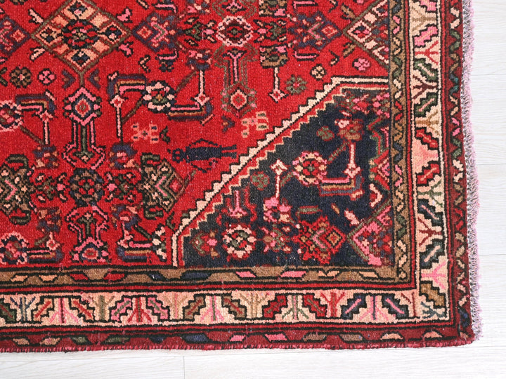 a red rug with a design on it