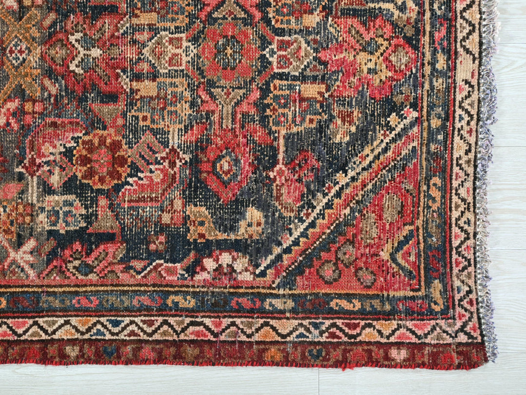 an antique persian rug is displayed on a white surface