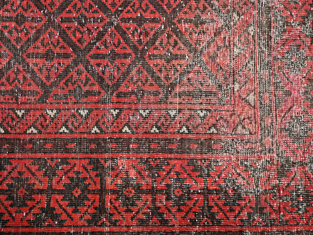 a close up of a red and black rug