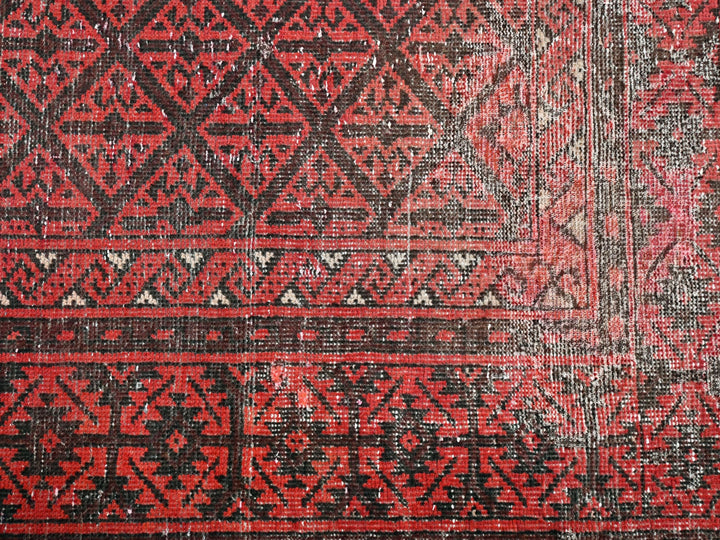 a close up of a red and black rug