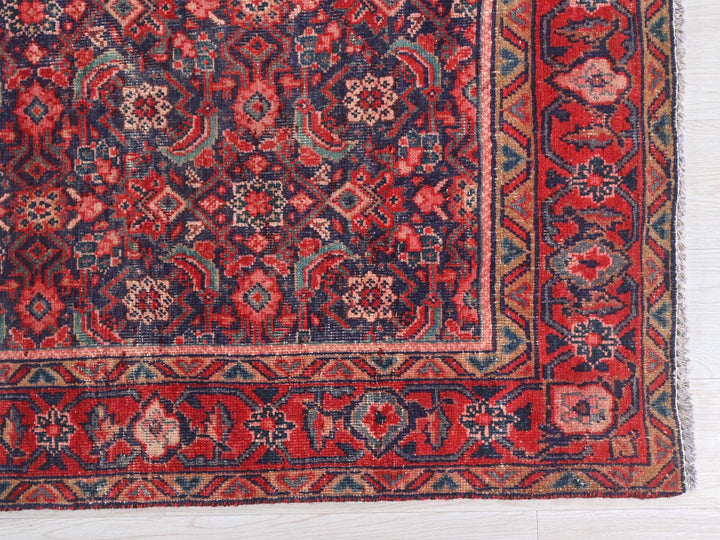 a red and blue rug on a white floor