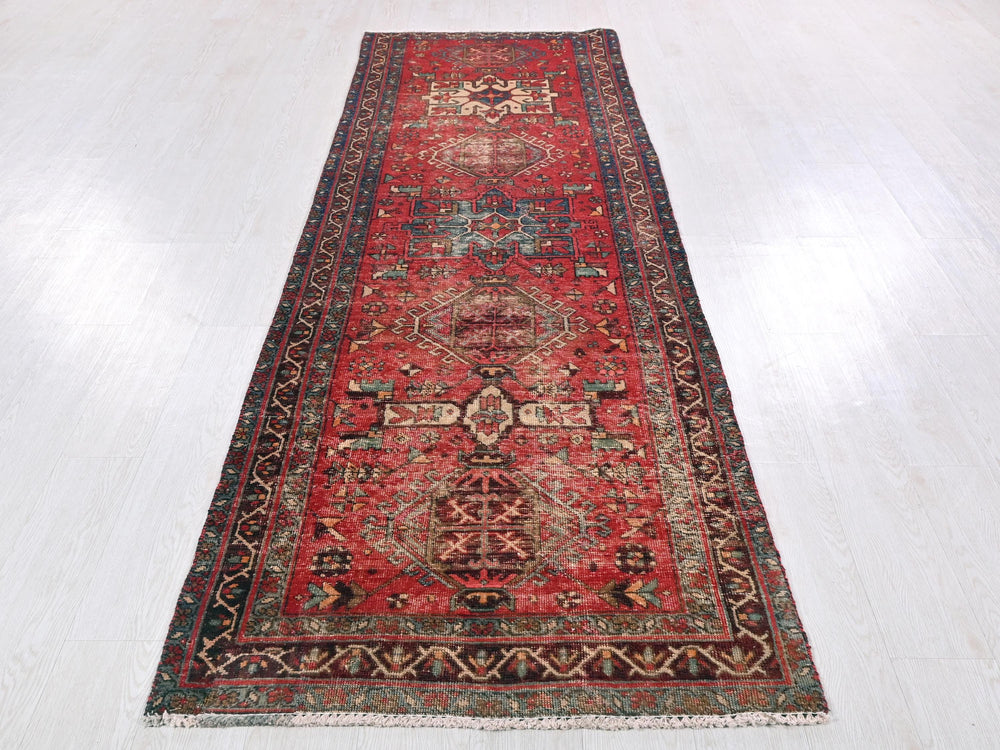 a long red rug on a white floor