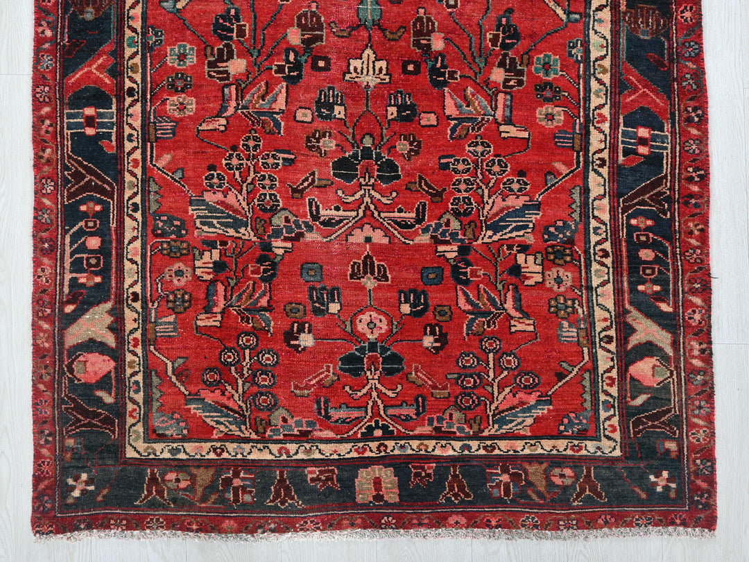 a red rug with a black border on a white wall