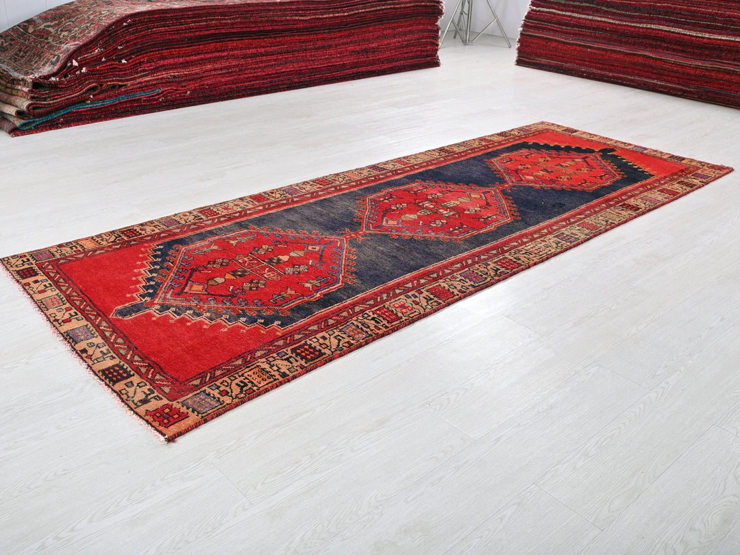 a pile of red rugs on a white floor