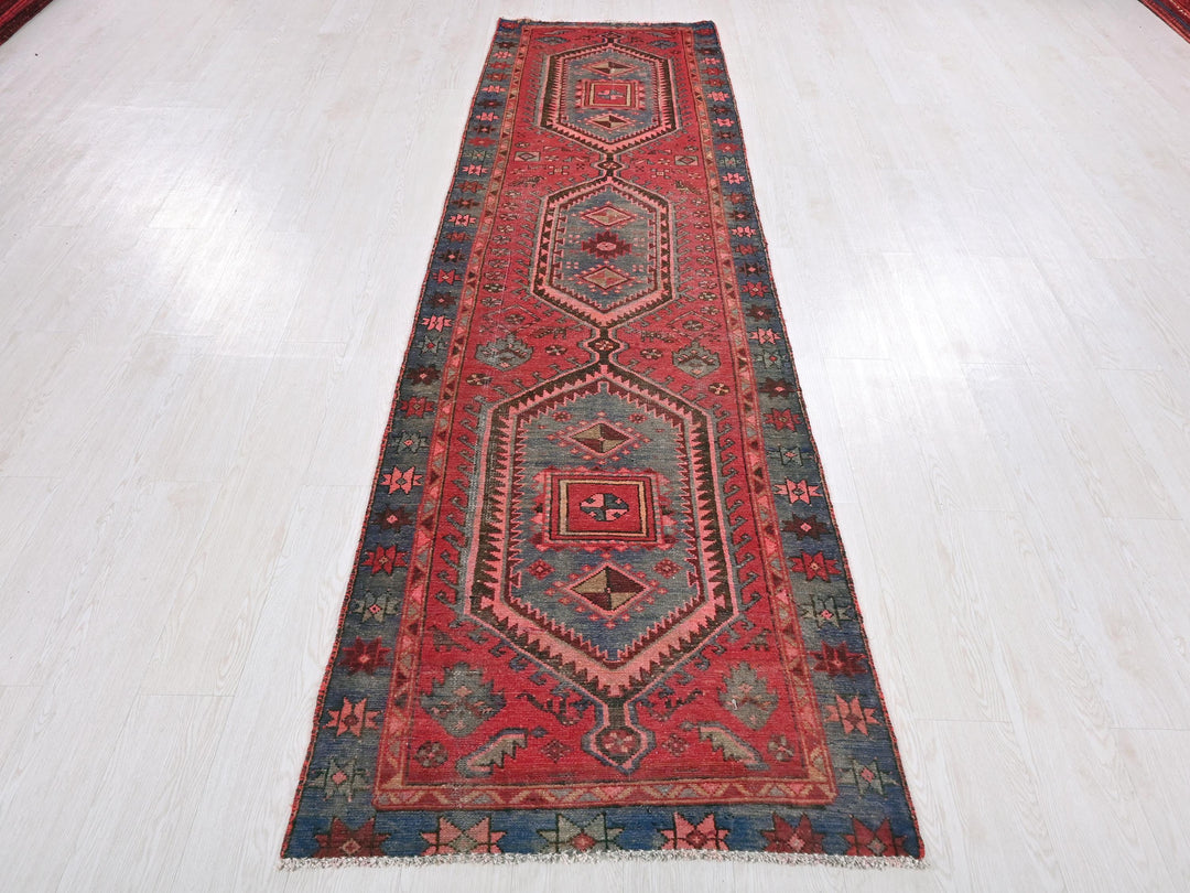 a long red rug on a white floor
