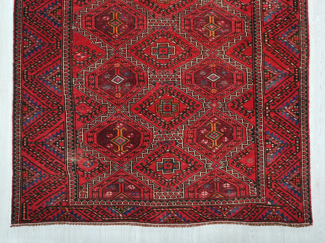 a red rug with a diamond pattern on it