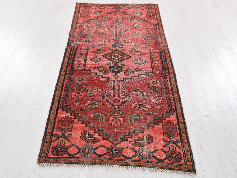 a red rug on a white floor in a room
