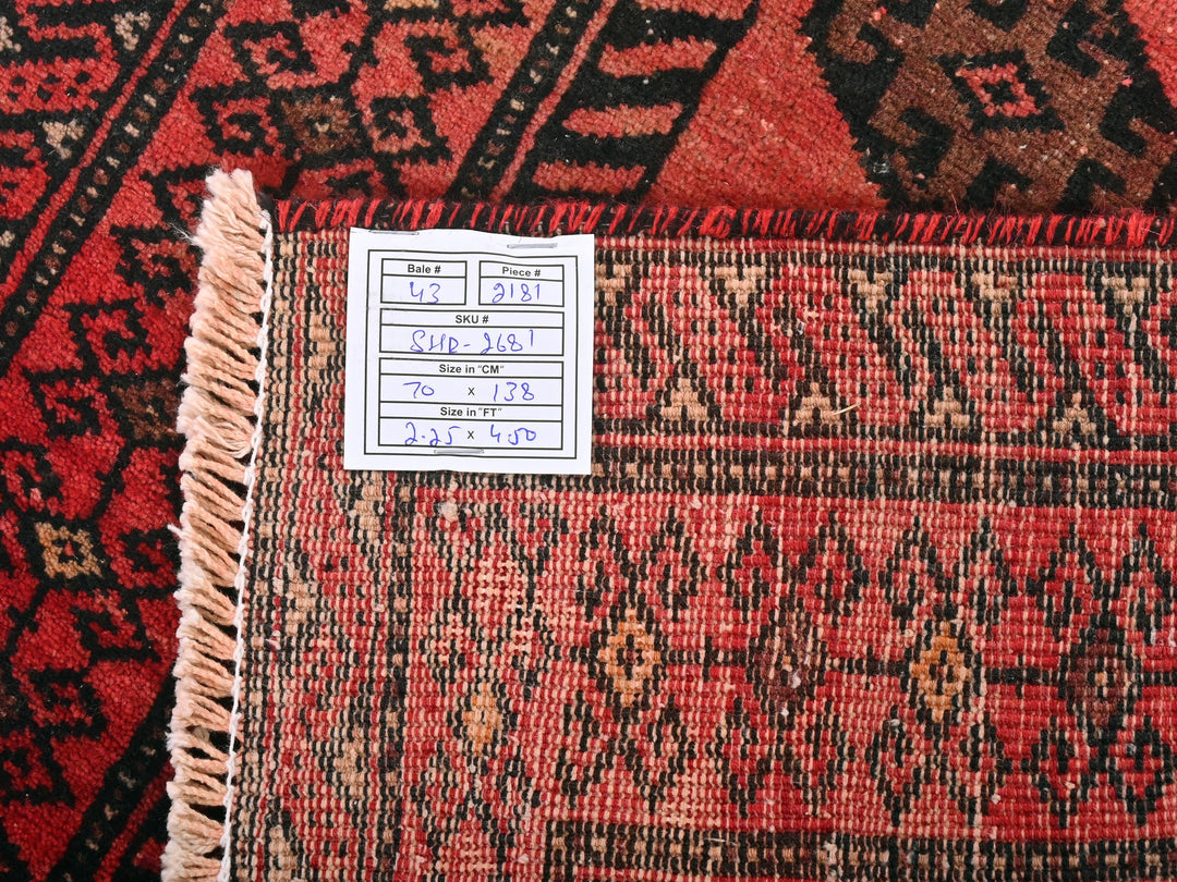 a pile of red and black oriental rugs