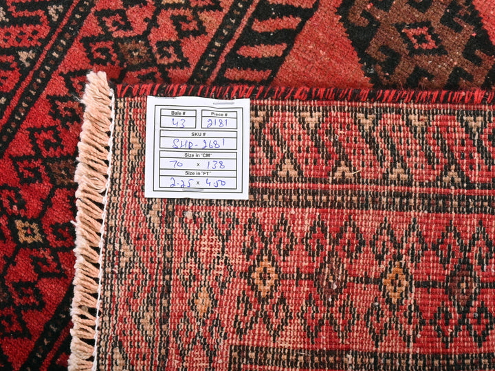 a pile of red and black oriental rugs