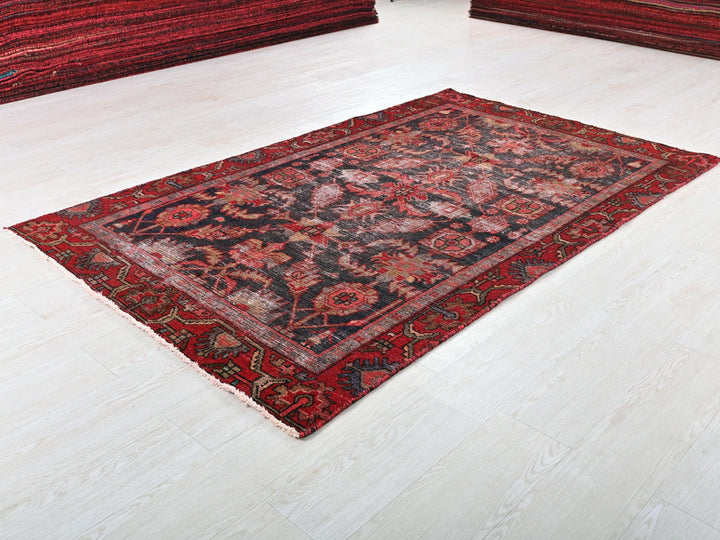 a red rug on a white floor in a room