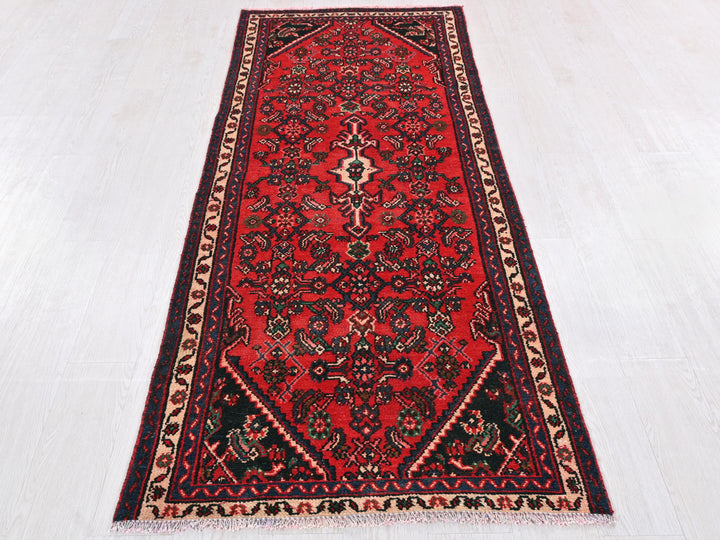a red rug on a white floor in a room