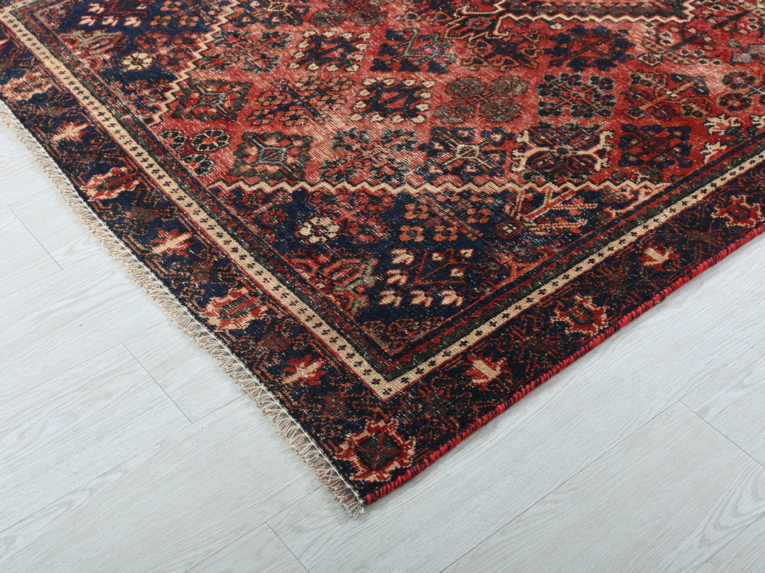 a red and blue rug on a white floor