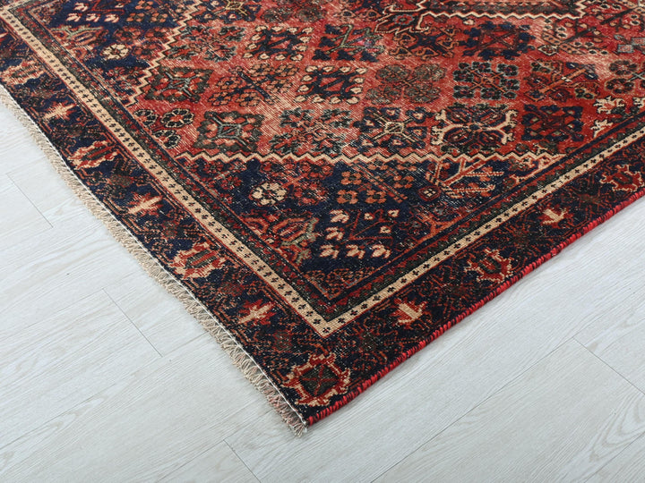 a red and blue rug on a white floor