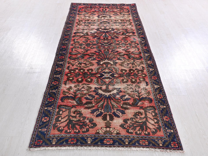 a red and blue rug on a white floor
