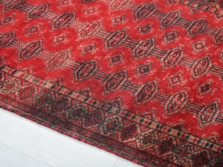a red rug with a pattern on it
