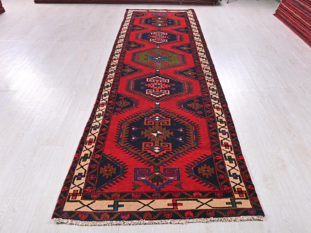 a long red rug on a white floor