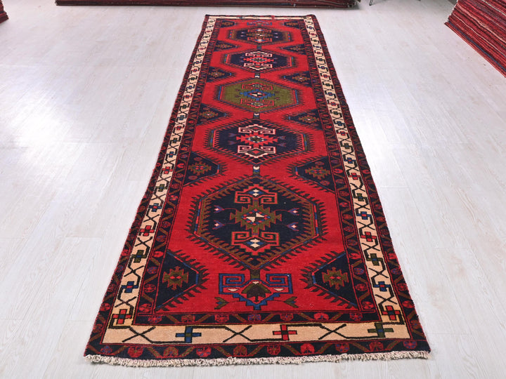 a long red rug on a white floor