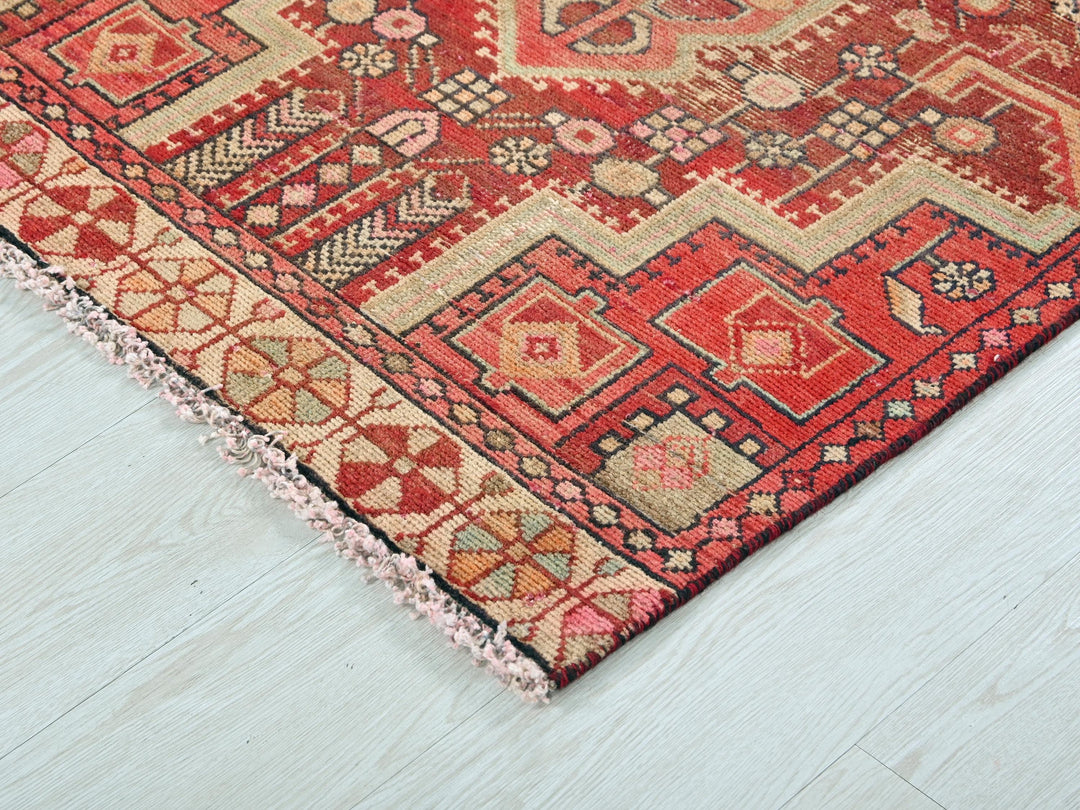 a red rug on a white wooden floor