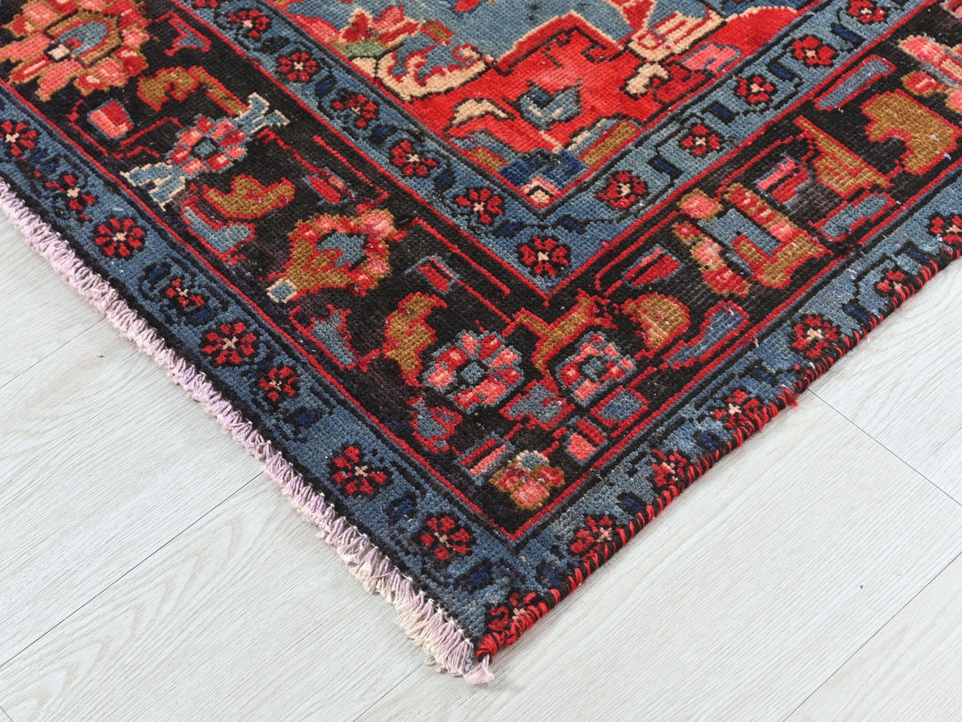 a red and blue oriental rug on a white floor