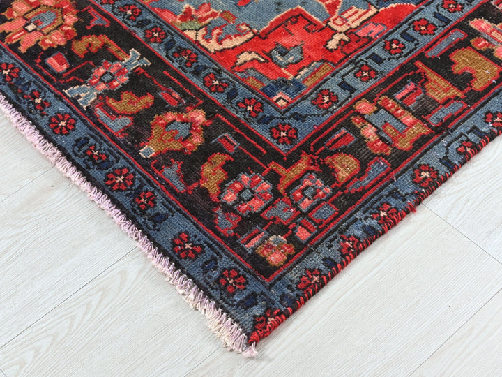 a red and blue oriental rug on a white floor