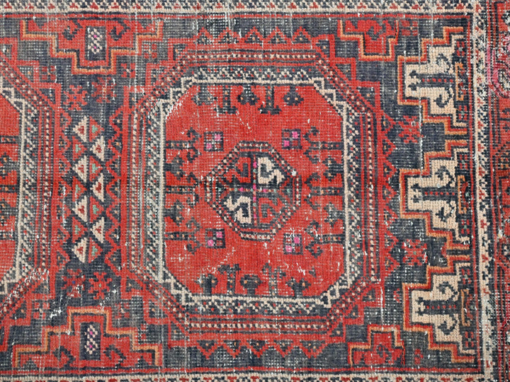 a red and blue rug with an intricate design