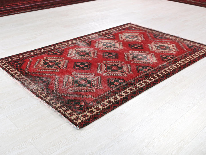 a red and black rug sitting on top of a white floor