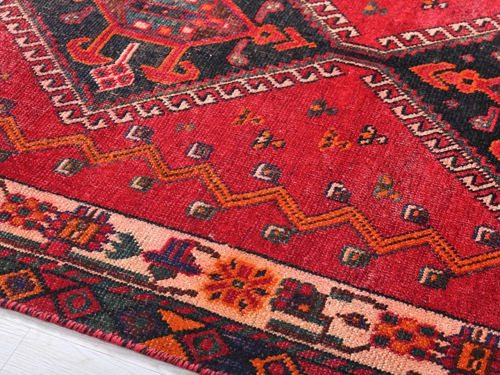 a close up of a red rug on the floor
