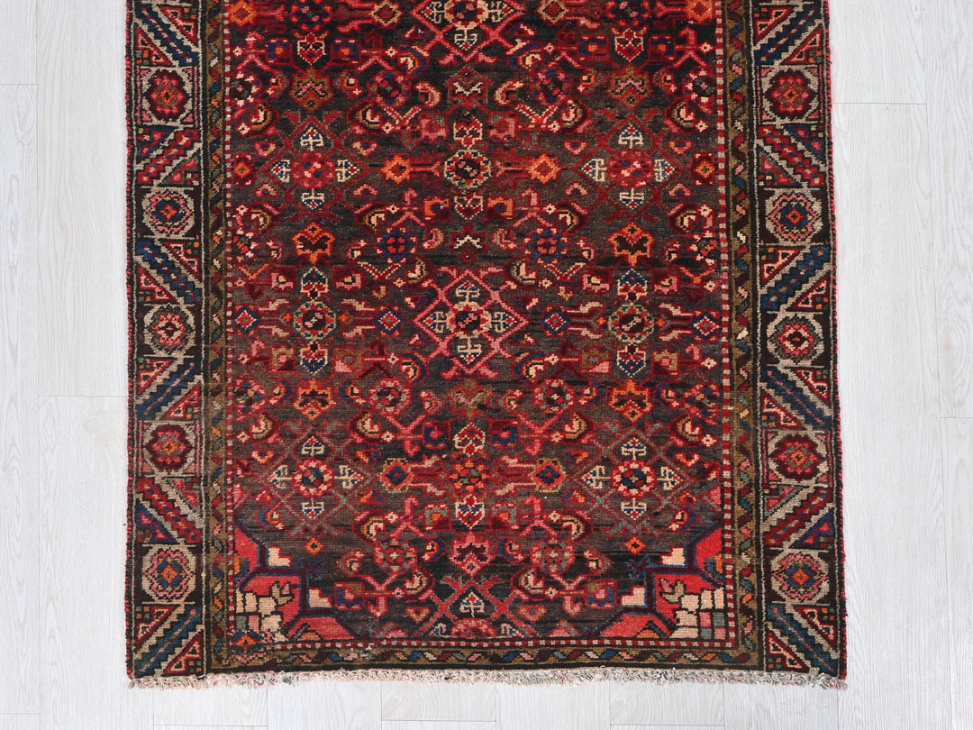 a red and blue rug on a white floor