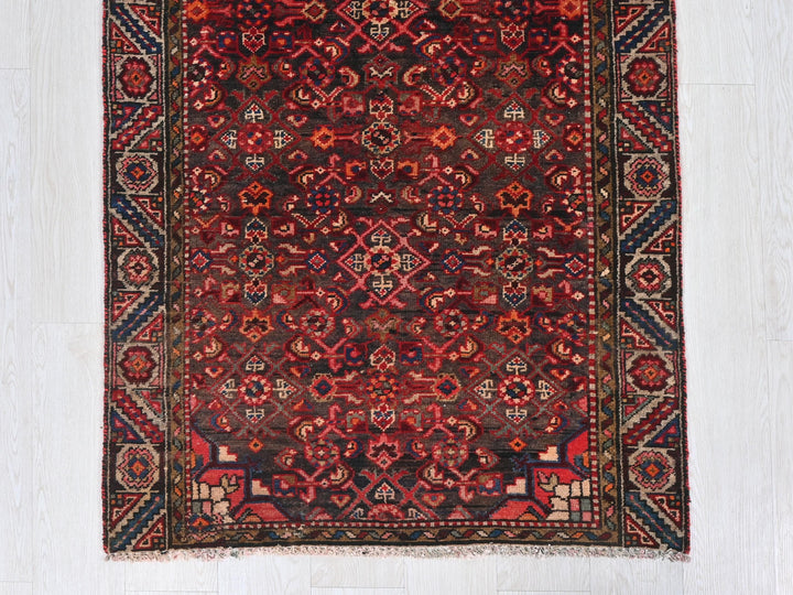a red and blue rug on a white floor