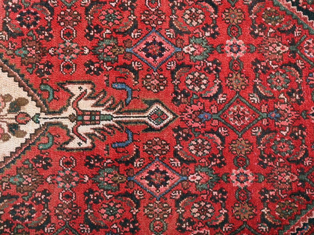 a red oriental rug with a black border