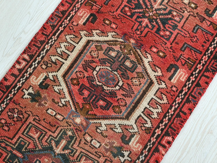 a red rug on a white wooden floor