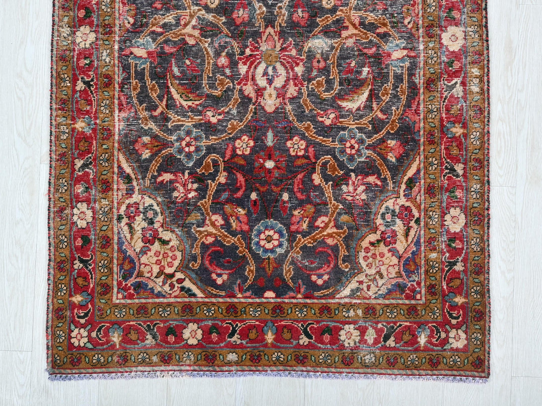 a red and blue rug on a white floor
