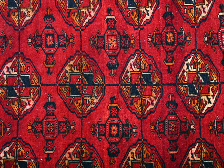 a close up of a red rug with a pattern on it