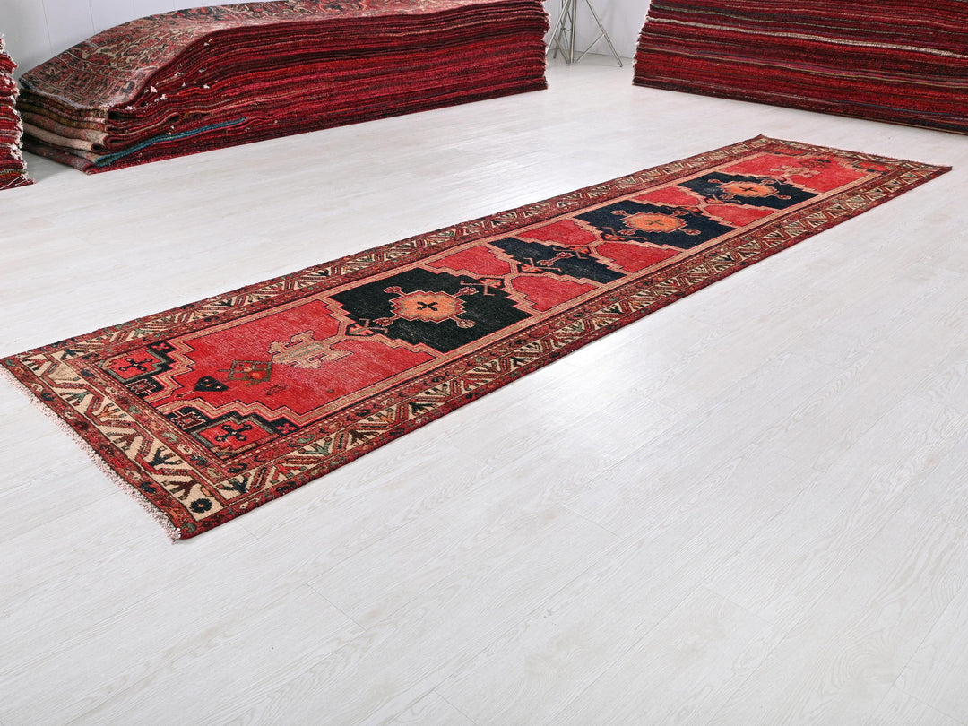 a pile of red rugs sitting on top of a white floor