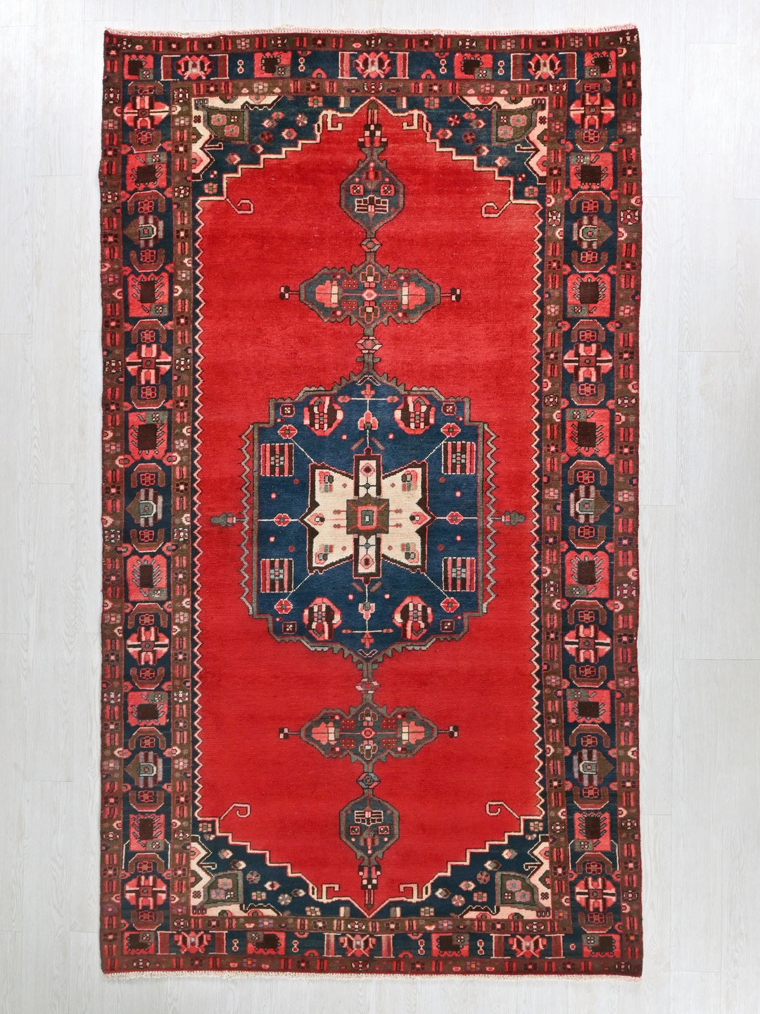 a red rug with a blue and red design