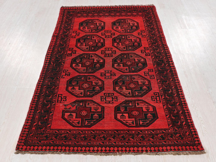 a red and black rug on a white floor