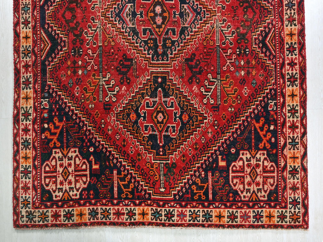 a red rug with an intricate design on it