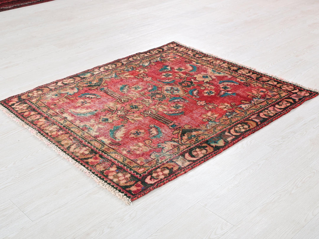 a red rug on the floor of a room