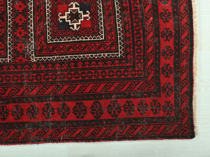 a red rug with black and white designs on it