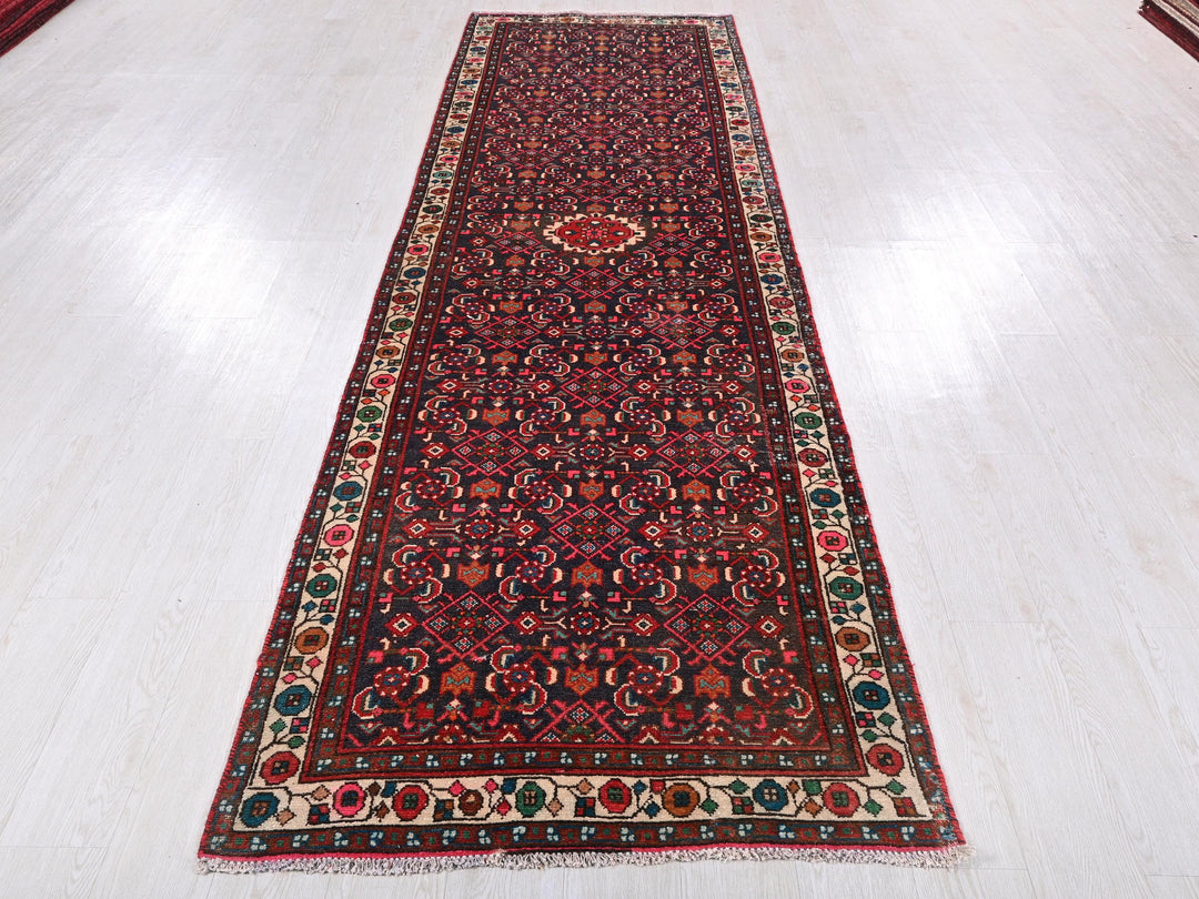 a long red rug on a white floor
