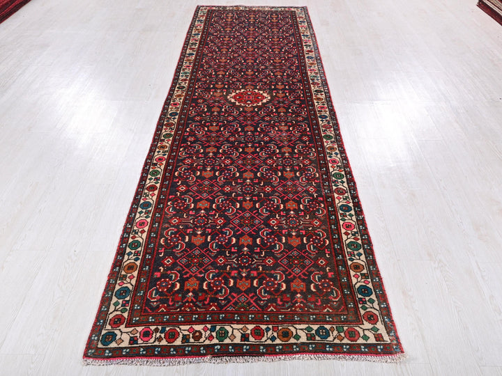 a long red rug on a white floor